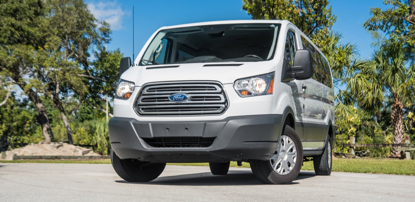 White Ford Transit passenger van